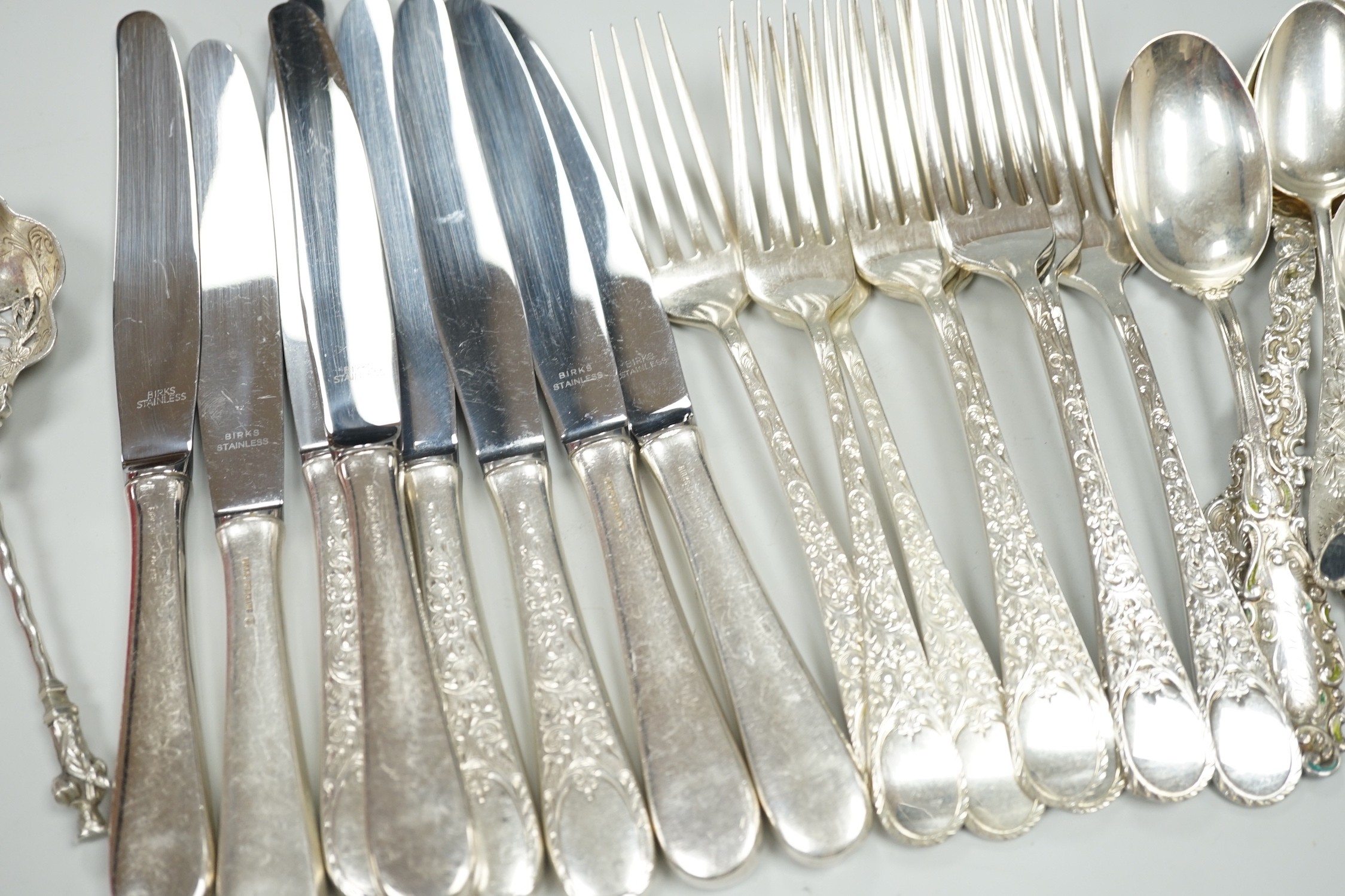 Five Canadian Birks sterling table forks, one sterling teaspoon and six sterling handled table knives, together with seven items of sterling flatware, a Hanau white metal ornate spoon and fifteen items of Birks Regency p